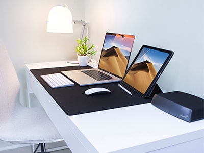 A modern tech office with a sleek laptop and a tablet